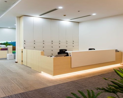 A modern office lobby in Jakarta showing realistic editorial workspace environment