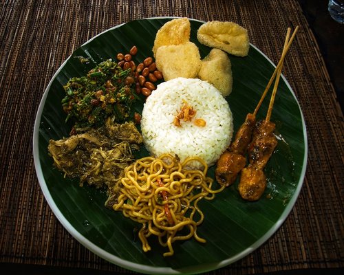 Traditional Indonesian home cooked meal featuring rice, tempeh, and vegetables on a plate